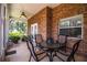 Inviting screened patio featuring a brick wall, ceiling fan, and an outdoor dining set at 909 Lake Deeson Pt, Lakeland, FL 33805
