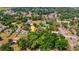 An aerial view of a home with a pool nestled among trees, marked with a location pin in a scenic area at 3822 Charter Rd, Lakeland, FL 33810