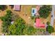 Expansive aerial view of a home with a pool, red roof, large lot, and mature trees, in a peaceful setting at 3822 Charter Rd, Lakeland, FL 33810