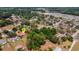 Aerial view of a red roof home among lush trees in a tranquil neighborhood, marked with a location pin at 3822 Charter Rd, Lakeland, FL 33810