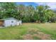 Large backyard with a storage shed, mature trees, and recreational areas at 3822 Charter Rd, Lakeland, FL 33810