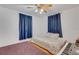 Cozy bedroom offers lots of light from the windows, hardwood flooring, and a comfortable bed at 3822 Charter Rd, Lakeland, FL 33810