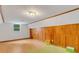 Unfinished bonus room features wood paneling and flooring with a small window at 3822 Charter Rd, Lakeland, FL 33810