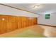 Bright bonus room with wood paneling and flooring with a small window at 3822 Charter Rd, Lakeland, FL 33810