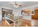 Open dining room leading to a kitchen with wooden cabinets and stainless steel appliances at 3822 Charter Rd, Lakeland, FL 33810