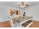 The dining room features a wooden table, white chairs, and a view into the kitchen at 3822 Charter Rd, Lakeland, FL 33810