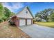 Home with brick accents, two-car garage, gable roof, and well-maintained concrete driveway at 3822 Charter Rd, Lakeland, FL 33810