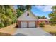 Home featuring a two-car garage, brick accents, gable roof, and well-maintained driveway at 3822 Charter Rd, Lakeland, FL 33810