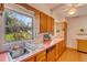 Sunny kitchen with retro design featuring wood cabinets, vintage appliances, and garden view at 3822 Charter Rd, Lakeland, FL 33810