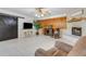 Bright living room features painted brick fireplace, tile floors, wood accent wall, and barn door at 3822 Charter Rd, Lakeland, FL 33810