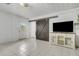 Bright living room features a sliding barn door, tile flooring, and built in cabinets at 3822 Charter Rd, Lakeland, FL 33810