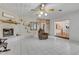 Cozy living room with tile floors, painted brick fireplace, decorative shelving, and open floor plan at 3822 Charter Rd, Lakeland, FL 33810