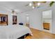 Well-lit main bedroom with hardwood floors, closet, ensuite bathroom and a decorative ceiling fan at 3822 Charter Rd, Lakeland, FL 33810