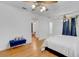 Bright main bedroom with hardwood floors, ensuite bathroom, and decorative ceiling fan at 3822 Charter Rd, Lakeland, FL 33810