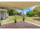 Covered patio with brick pavers overlooking a spacious, green backyard at 3822 Charter Rd, Lakeland, FL 33810