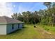 A spacious backyard with a lush green lawn and dense trees, providing ample privacy and shade at 10470 Sw 139Th Ct, Dunnellon, FL 34432
