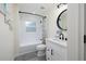 Modern bathroom with a shower-tub combination, white subway tile, and a stylish vanity at 10470 Sw 139Th Ct, Dunnellon, FL 34432
