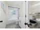 Bright bathroom featuring a shower-tub combination, subway tiles, and a shelved linen closet at 10470 Sw 139Th Ct, Dunnellon, FL 34432
