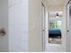 Walk-in shower with marble tile, shower head with brass finish, doorway to the bedroom at 10470 Sw 139Th Ct, Dunnellon, FL 34432