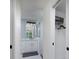 Modern bathroom featuring walk-in shower, gray vanity, and a closet with storage at 10470 Sw 139Th Ct, Dunnellon, FL 34432