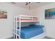 Bright bedroom featuring a bunk bed with a blue mattress, complemented by modern decor and a ceiling fan at 10470 Sw 139Th Ct, Dunnellon, FL 34432