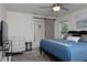 Bedroom featuring sliding barn door, white couch, and neutral paint at 10470 Sw 139Th Ct, Dunnellon, FL 34432