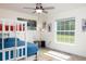 Bright bedroom with a bunk bed, large window offering ample natural light, and stylish decor at 10470 Sw 139Th Ct, Dunnellon, FL 34432