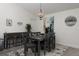 Cozy dining room with stylish wood table, seating for six, and a unique light fixture at 10470 Sw 139Th Ct, Dunnellon, FL 34432