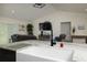 Kitchen island with farmhouse sink, pendant lighting and a view into the living room at 10470 Sw 139Th Ct, Dunnellon, FL 34432