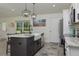 Kitchen island with barstool seating, marble countertops, and a farmhouse style sink at 10470 Sw 139Th Ct, Dunnellon, FL 34432