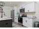 Kitchen with stainless appliances, marble countertops, and white shaker cabinets at 10470 Sw 139Th Ct, Dunnellon, FL 34432