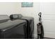 Well-equipped laundry room featuring modern, dark-colored washer and dryer units at 10470 Sw 139Th Ct, Dunnellon, FL 34432