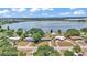 An aerial shot of the lakefront home with mature trees and a large lake in the background at 118 Lake Sears Dr, Winter Haven, FL 33880