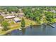 An aerial view of the lakefront property with lush trees, a dock, and a lakefront view at 118 Lake Sears Dr, Winter Haven, FL 33880