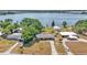 An aerial view of a lakeside home with mature trees and a long driveway leading up to the house at 118 Lake Sears Dr, Winter Haven, FL 33880