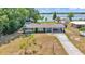 Aerial view of a home near a lake, surrounded by mature trees at 118 Lake Sears Dr, Winter Haven, FL 33880