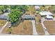 An aerial view shows the home and the property's spacious front yard and mature landscaping at 118 Lake Sears Dr, Winter Haven, FL 33880