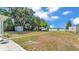 Expansive backyard with lush trees and a view of the lake at 118 Lake Sears Dr, Winter Haven, FL 33880