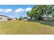 Spacious backyard with outbuildings, shed, and mature trees at 118 Lake Sears Dr, Winter Haven, FL 33880