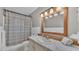 Bathroom with a framed mirror, shower with curtain, and neutral-colored vanity at 118 Lake Sears Dr, Winter Haven, FL 33880