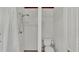 Bathroom with walk-in shower with curtain, toilet, and white walls at 118 Lake Sears Dr, Winter Haven, FL 33880