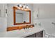 Well-lit bathroom featuring vanity with wood accents and a mirror at 118 Lake Sears Dr, Winter Haven, FL 33880
