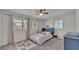 Cozy bedroom featuring a ceiling fan, two windows, and an area rug at 118 Lake Sears Dr, Winter Haven, FL 33880