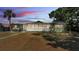 Charming single-story home with a screened-in porch and lush landscaping at 118 Lake Sears Dr, Winter Haven, FL 33880
