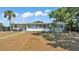 Charming single-story home with a screened-in porch and lush landscaping at 118 Lake Sears Dr, Winter Haven, FL 33880