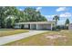 Well-maintained home featuring a covered carport, tidy landscaping, and a spacious driveway at 118 Lake Sears Dr, Winter Haven, FL 33880