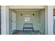 Inviting covered porch with a bench, decorative lights, and a view of the lake at 118 Lake Sears Dr, Winter Haven, FL 33880