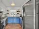 Updated kitchen with stainless steel appliances and blue cabinets at 118 Lake Sears Dr, Winter Haven, FL 33880