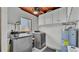 Functional laundry room featuring a washer, dryer, water heater, and storage at 118 Lake Sears Dr, Winter Haven, FL 33880