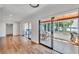 Bright living room with hardwood floors, screened porch access, and water view at 118 Lake Sears Dr, Winter Haven, FL 33880